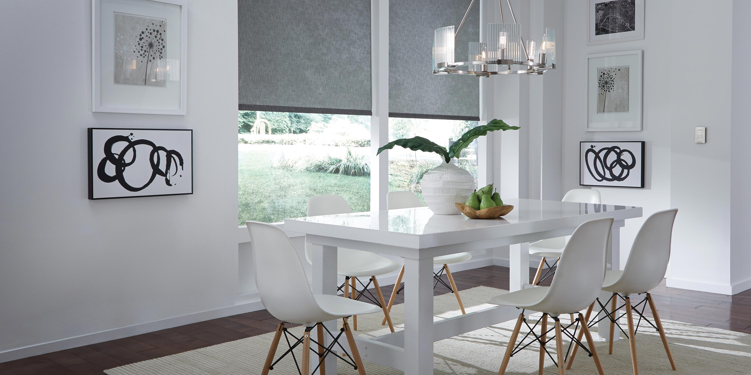 Lutron halfway open shades with control on the wall in a white dining room